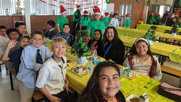 Students dress up and get served a fine meal. 